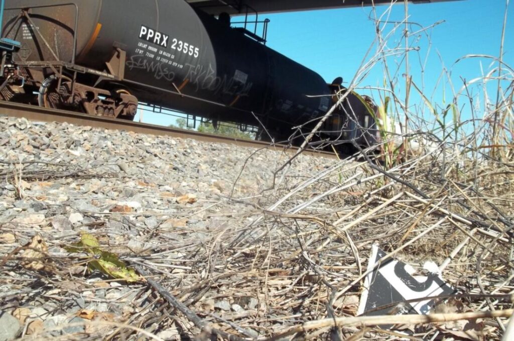 Damaged placard with id by rail